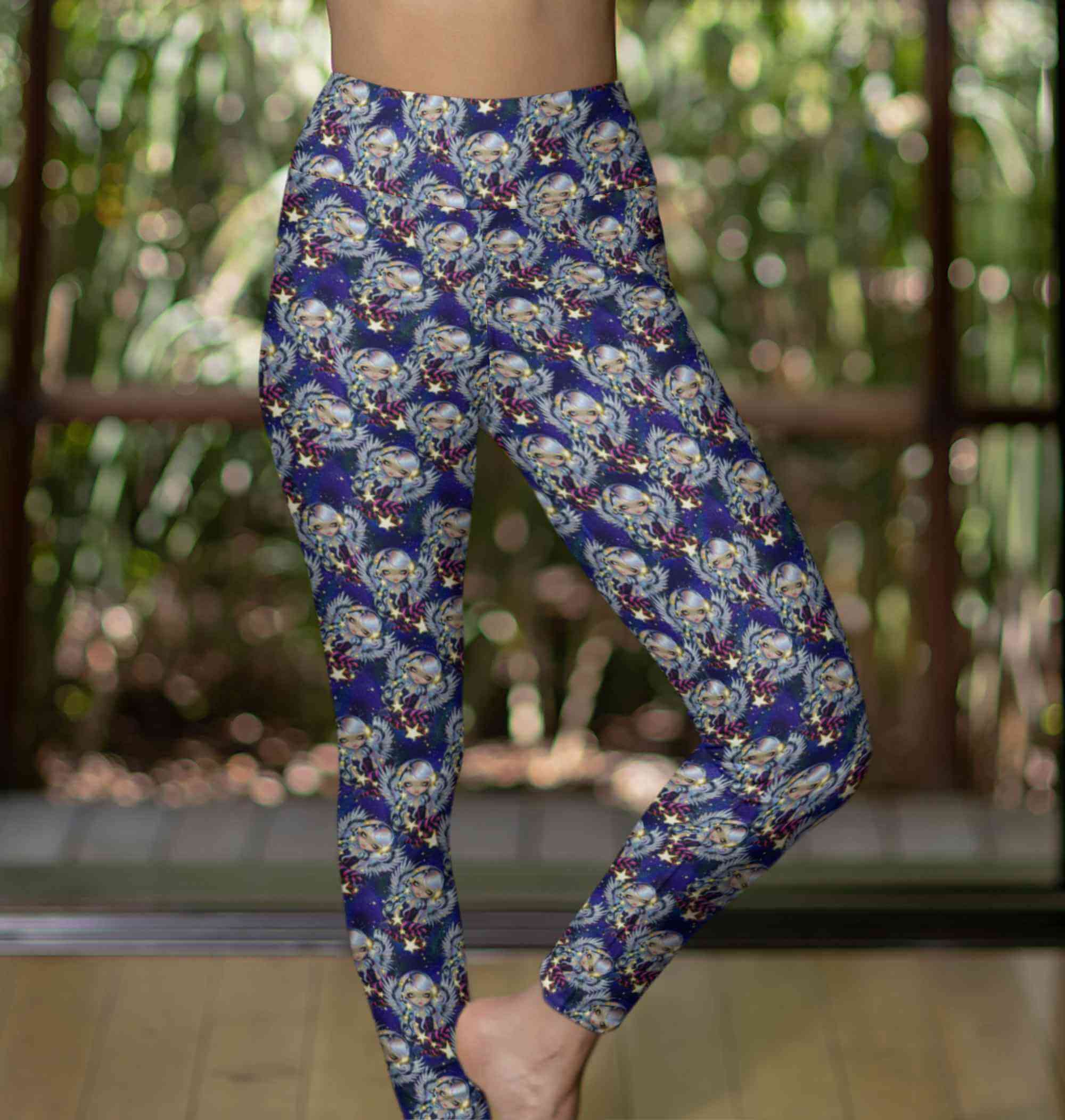 lady in a yoga pose wearing Celestial Angel of Starlight - Strangelings Leggings by artist Jasmine Becket-Griffith with silver-haired angels, glowing stars and a deep galaxy background in blues and purples by Nikki Whoops Boutique.