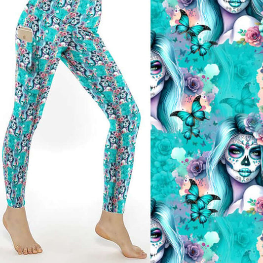 mock up of Ethereal Elegance Day of the Dead Full-Length Leggings featuring sugar skull women with flowing blue hair, surrounded by butterflies and roses on an aqua background.