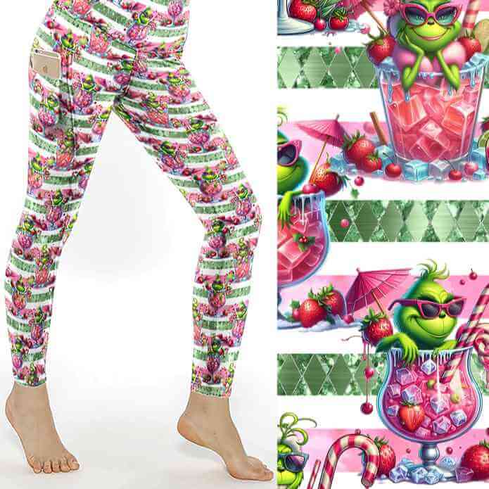 Festive leggings with green Grinch-like character lounging in pink cocktail glasses on a pink and white striped background with candy canes and fruit by Nikki Whoops Boutique.
