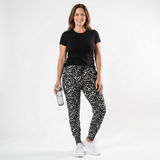 Woman wearing a black T-shirt and gray and black leopard-print jogger pants
