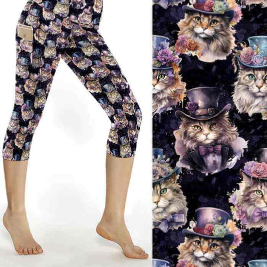 mockup of capri-length leggings featuring a pattern of dressed cats in Victorian attire on a dark background. The leggings are capri-length, with a high waistband and integrated side pockets.