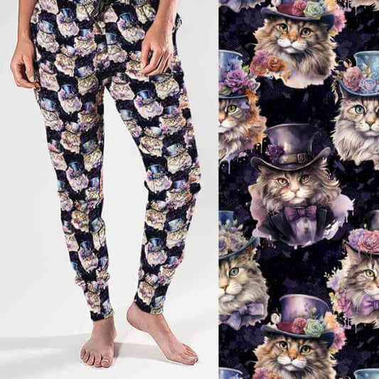 A pair of women's full-length joggers featuring a colorful print of cats wearing Victorian-style clothing against a dark background. The joggers are displayed from two angles, one showcasing the front view and the other highlighting the back.