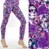 Mockup of Violet Femmes leggings. La Catrina images with flowing hair with tints of pink, mauve and blue. vibrant pink and purple flowers in their hair on a rich purple background by Nikki Whoops Boutique.