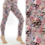 Dusty pink leggings featuring skulls, flowers, and pastel butterflies in soft shades of pink, lilac, and blue on a romantic floral background.