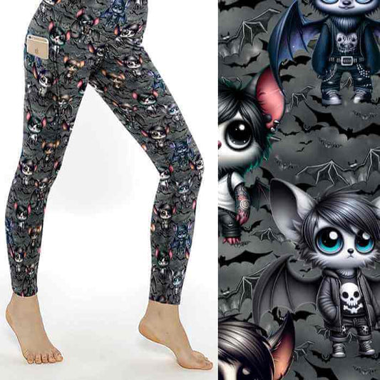 A pair of women's leggings featuring a pattern with cartoon emo bats in various poses and expressions, predominantly in shades of gray, with side pockets.