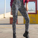 girl wearing leggings featuring a pattern with cartoon emo bats in various poses and expressions, predominantly in shades of gray, with side pockets.