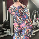 lady wearing leggings featuring vampire-inspired female portraits framed in gothic cameos with roses, set against a purple and fiery sunset background.