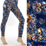 mockup of Blue Velvet Bones leggings. shimmering gold and dark blue skulls with delicate gold and blue flowers and butterflies on a vibrant dark blue background.