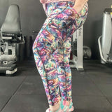 Person wearing colorful patterned leggings in a gym setting