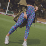 girl in a park wearing capri leggings featuring Jack & Sally characters in vibrant blues, purples, and greens, with swirling colourful accents