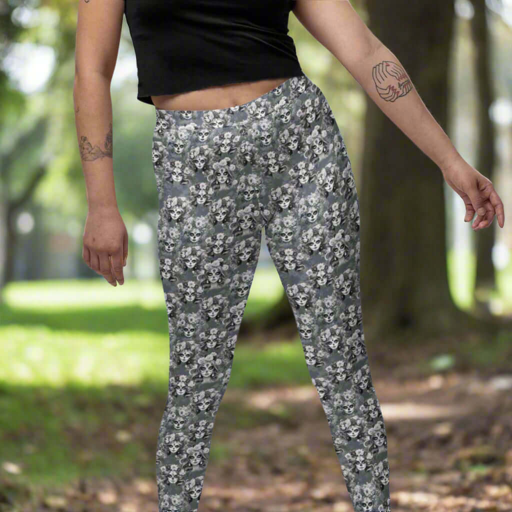 lady wearing monochrome leggings of La Catrina, with floral patterns and a Day of the Dead theme.