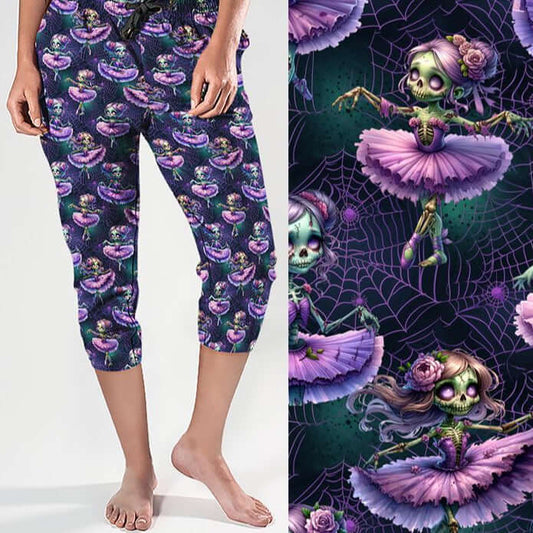mock up of A pair of capri joggers featuring a gothic-inspired design of eerie zombie ballerinas. The ballerinas wear tattered lavender tutus, have glowing purple eyes, skeletal hands, and flowing hair decorated with roses. The dark background features spiderwebs and ghostly details, enhancing the spooky yet whimsical aesthetic.