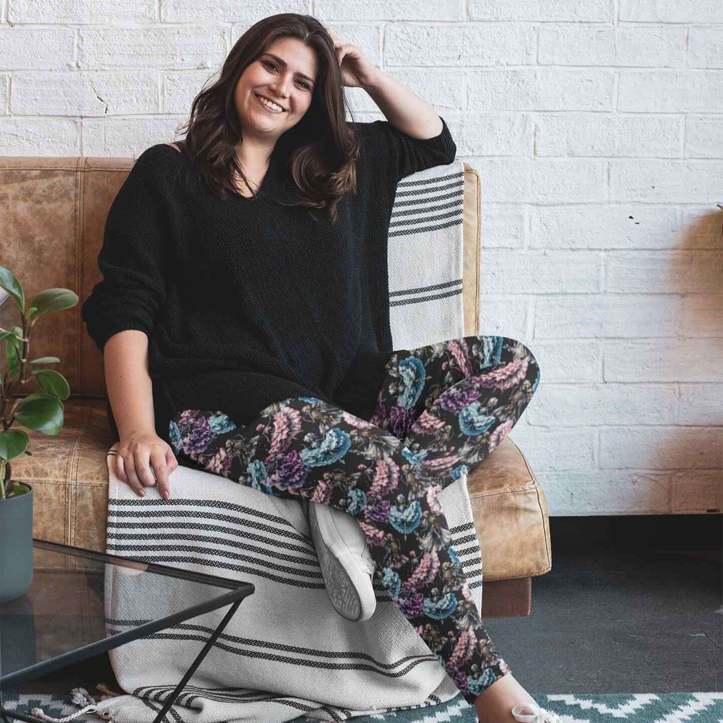 plus size lady wearing Danse Macabre Skull Leggings featuring skeletons dancing in gothic attire with muted grey and purple tones on a moody background.