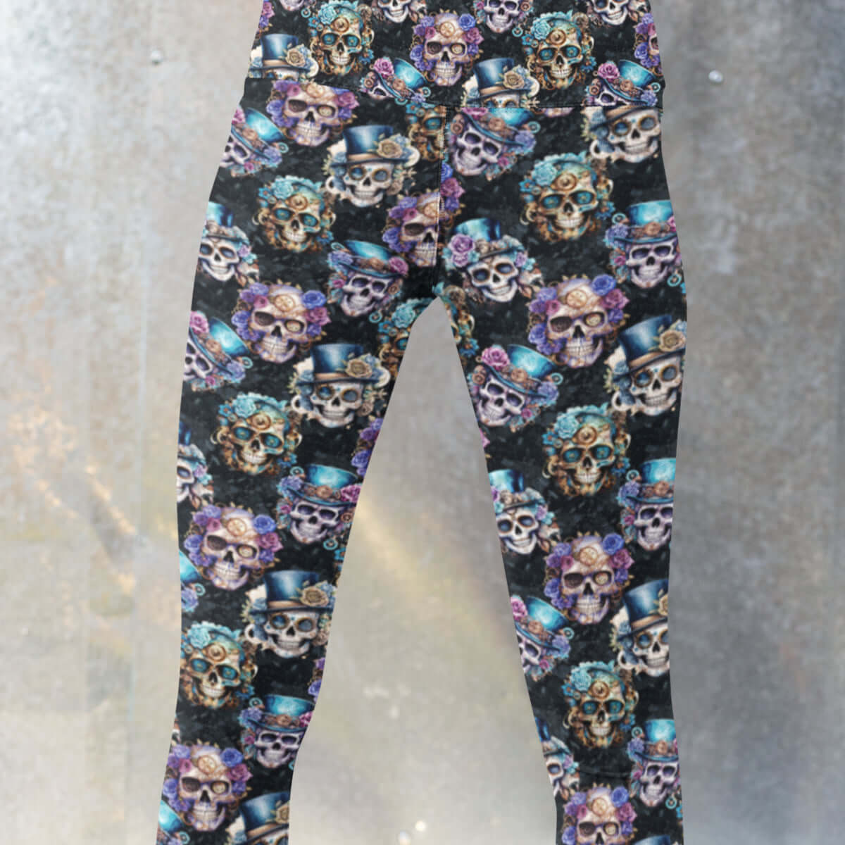 girl wearing leggings featuring a steampunk skull design with colorful skulls adorned with top hats and roses, set against a black background.