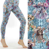 stock image of Dead Drunk But Dainty leggings with pink and lavender skeletons drinking cocktails on a soft pastel background.