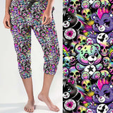 Capri jogger pants featuring punk pastel cartoon bears, rainbow skulls, stars, bats and spider webs on a bright purple background. Colourful, edgy and cute with attitude.