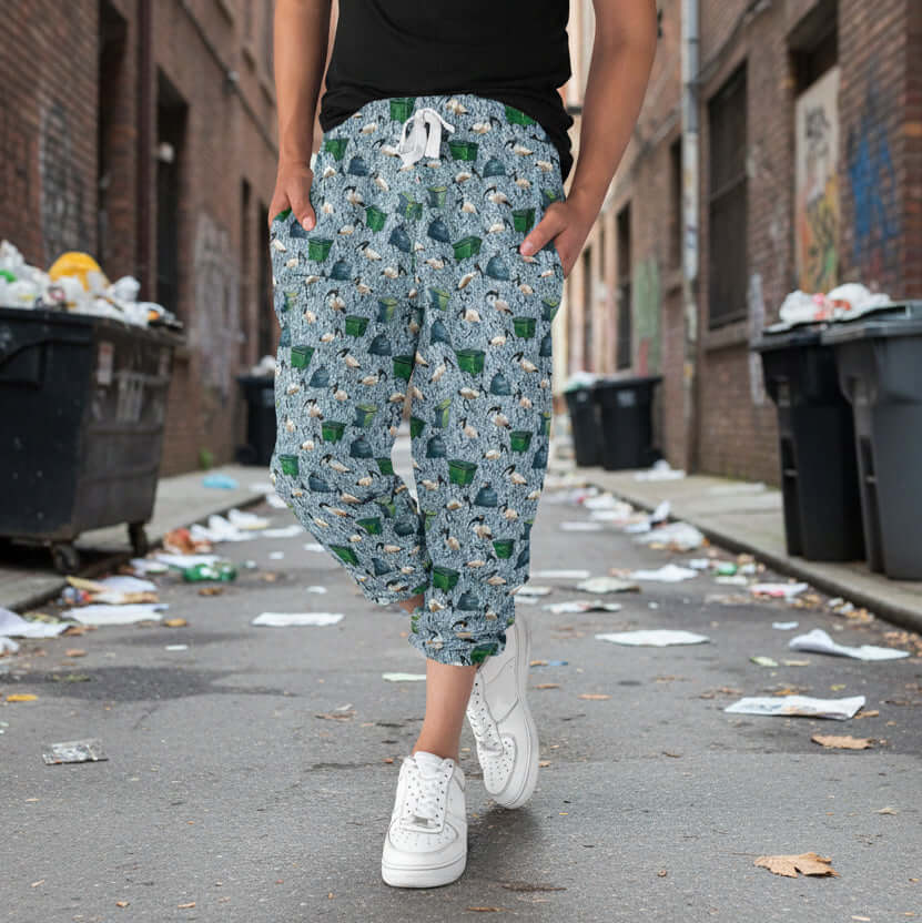 Person wearing ibis patterned capri joggers walking on a street with trash on the ground