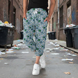 Person wearing ibis patterned capri joggers walking on a street with trash on the ground