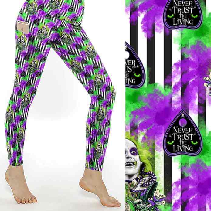 Leggings with green, purple, and black striped pattern, featuring Beetlejuice and text reading Never Trust the Living.