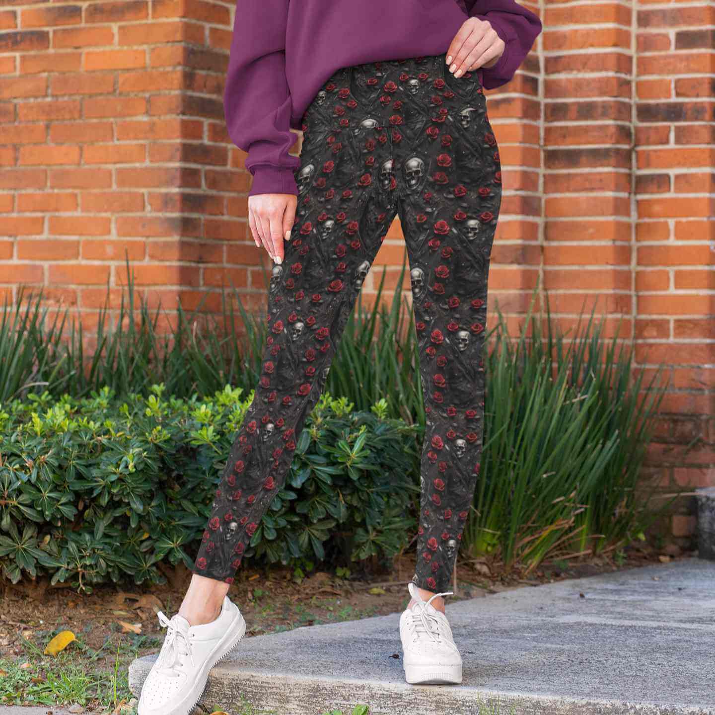 mockup-of-a-woman-wearing-high-waisted-leggings Gothic leggings with black leather texture, red roses, silver skulls and zippers entwined with vines.