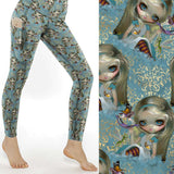 Looking Glass Insects Strangelings full length leggings feature whimsical doll and insect art, pockets, and a flattering high waistband.