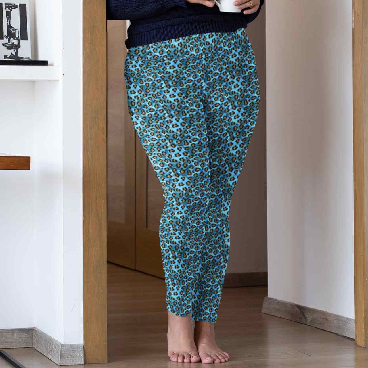 Person wearing blue leopard print pants standing in a doorway.