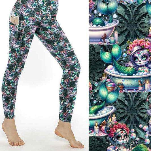A pair of leggings featuring a whimsical design with mermaids, sea creatures, and Day of the Dead-inspired makeup and garlands.