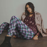 mockup of girl wearing Anatomical heart leggings featuring detailed hearts entwined with soft florals on a deep moody background.