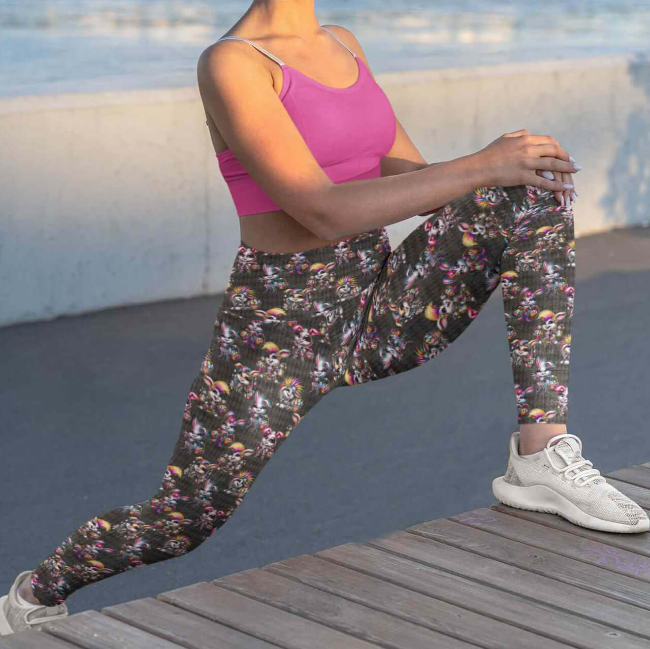 Ladt exercising wearing Rebel Rabbits Easter leggings featuring gothic lady bunnies with rainbow hair, mohawks. Wearing studded leather jackets, and boots . Holding baskets of brightly coloured Easter eggs