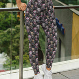 Woman wearing Sloth & Roll Capri leggings with punk rock sloth capri leggings featuring cute punk sloths with pink hair, wearing punk skull clothing