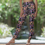 Lady in Wonderland-themed leggings with tea cups, white rabbits, checkered patterns and surreal elements in rich, moody colours.