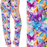A pair of colorful lounge pants featuring an all-over butterfly print in vibrant and pastel colors, with a wide waistband and drawstring.