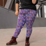 Person wearing 'Til Death Do We Party Skull Leggings colorful skull-patterned leggings and brown boots, standing outdoors in an urban environment by Nikki Whoops Boutique.