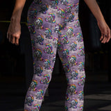girl wearing leggings with angry goth unicorns, drinking beer and wearing punk rock leather jackets, with rainbow mane, horn and tail.