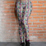 girl wearing Colorful leggings featuring zombie unicorns on a grunge burgundy, green and gold background