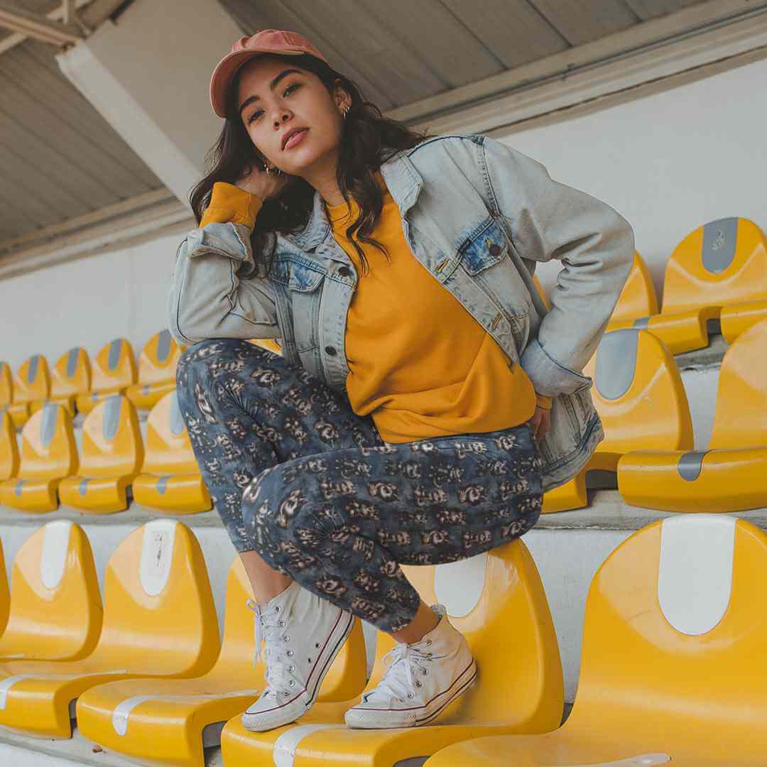 girl wearing emo unicorns on navy grunge background leggings