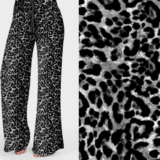A pair of palazzo lounge pants with a black and white leopard print design, featuring a high and wide waistband with drawstring.
