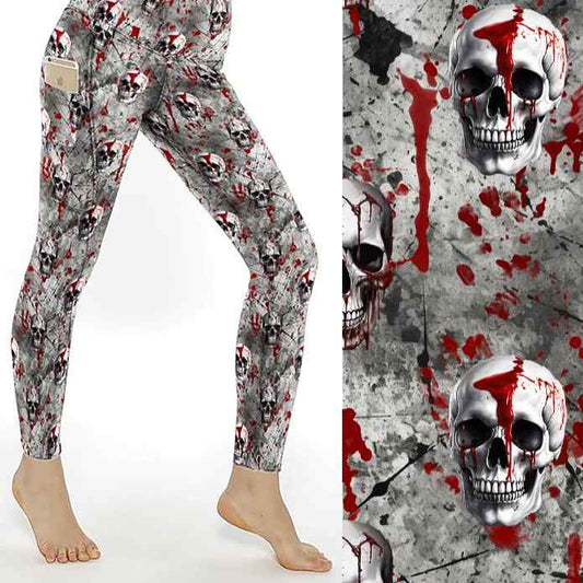 Leggings with skull and red blood splatter design on gray, close-up view of pattern and snug fit.