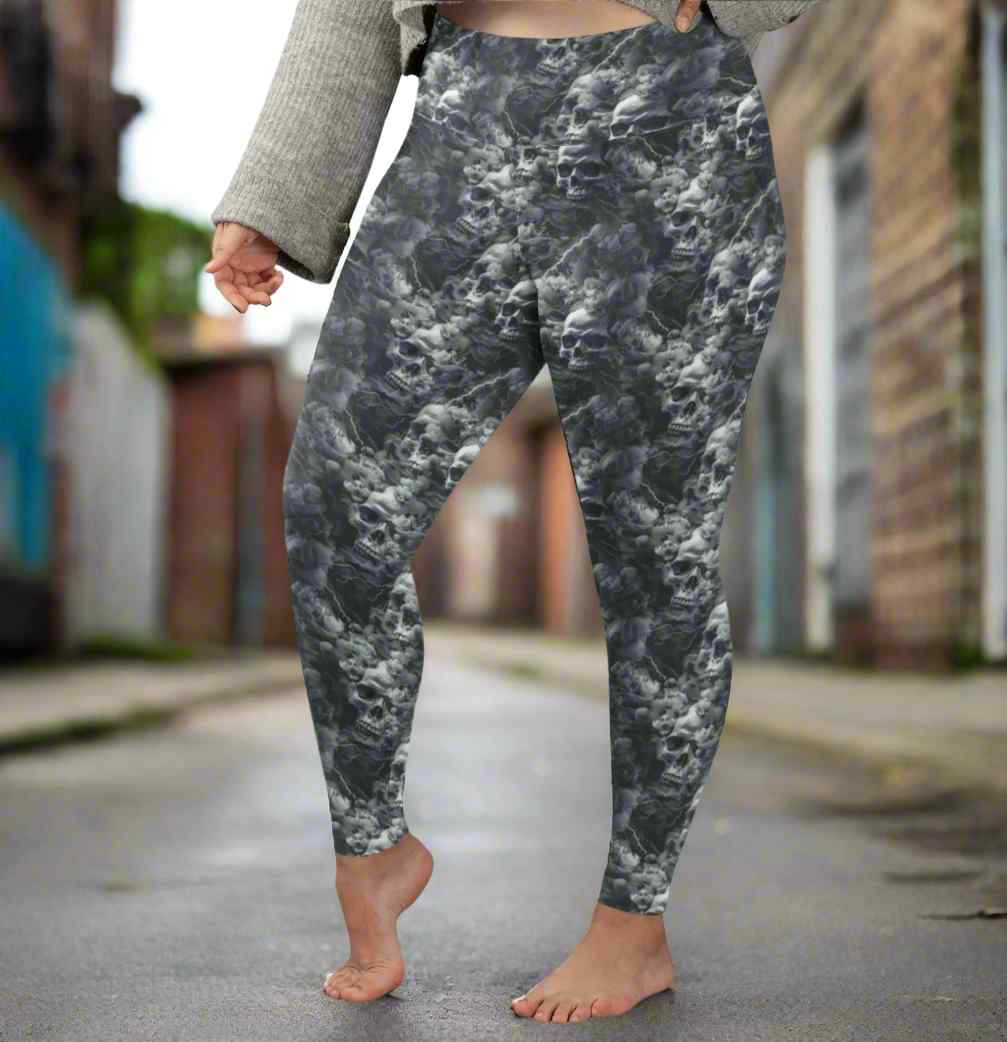 lady standing in an alleyway wearing Monochrome skull leggings with swirling storm clouds and lightning bolts on a dark smoky background.