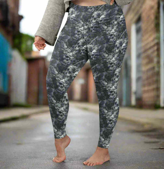 lady standing in an alleyway wearing Monochrome skull leggings with swirling storm clouds and lightning bolts on a dark smoky background.