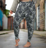 lady standing in an alleyway wearing Monochrome skull leggings with swirling storm clouds and lightning bolts on a dark smoky background.