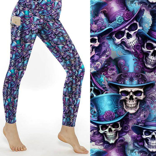 A pair of full-length leggings featuring a vibrant pattern with skulls wearing purple and turquoise top hats against a silver background.