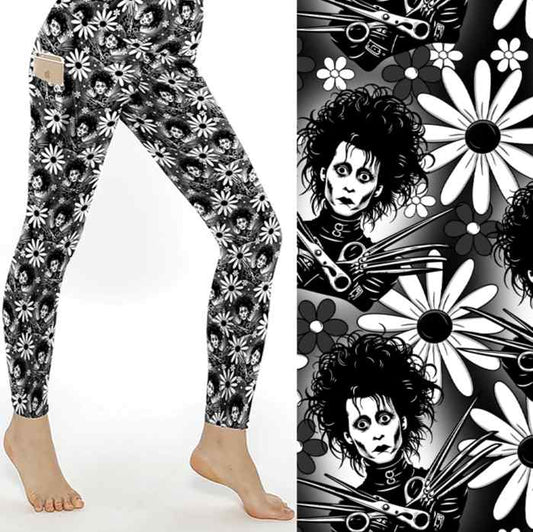 mock up of Black and white leggings with Edward Scissorhands faces surrounded by white daisies on a monochrome floral background. 