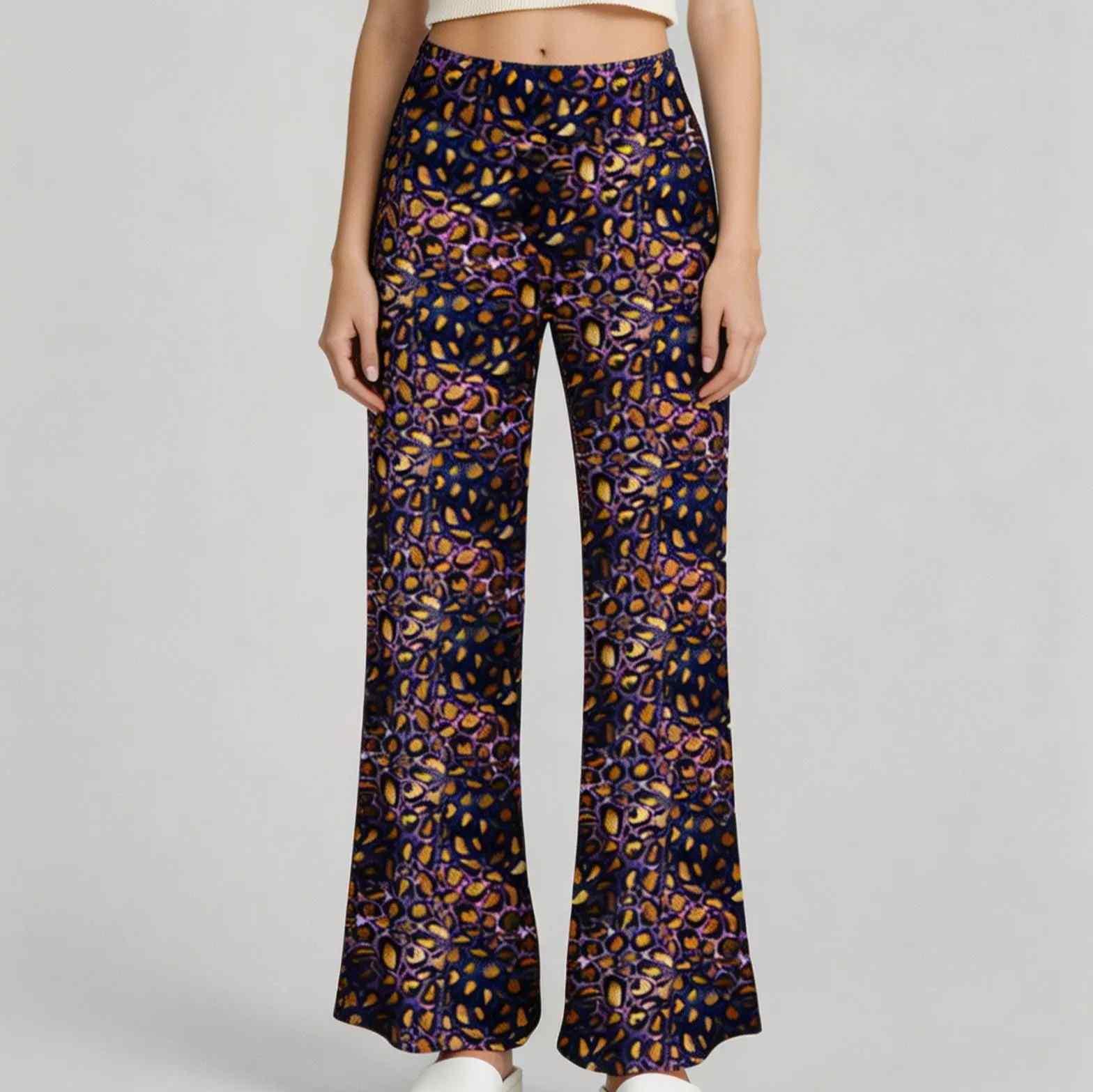 woman wearing wide leg lounge pants Jungle Queen Amethyst with amethyst purple and gold leopard print pattern on a dark background by Nikki Whoops Boutique. 