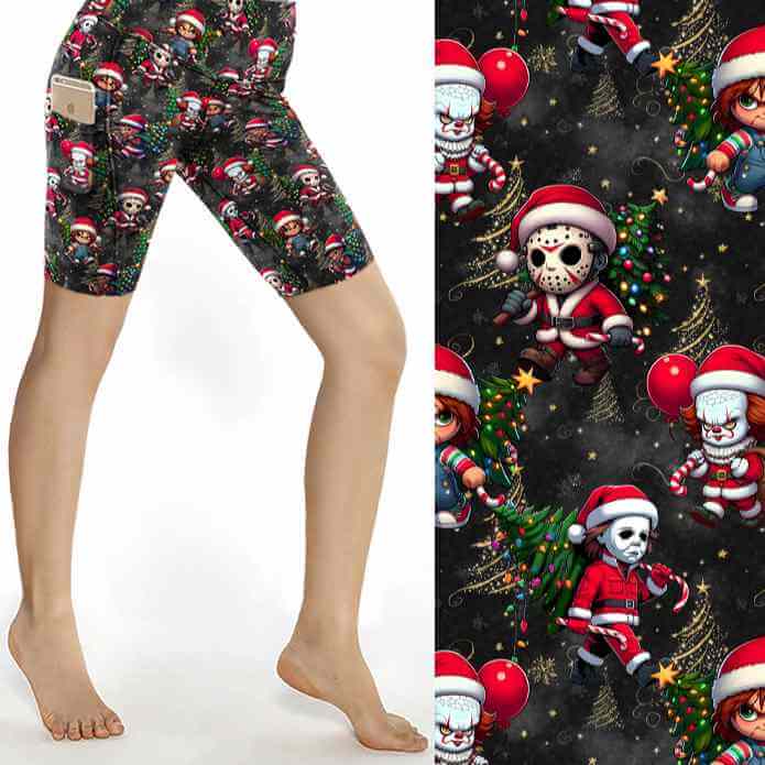Black Christmas sports shorts with chibi horror icons Freddy, Jason, Michael, Pennywise and Chucky in Santa outfits surrounded by gold stars and lights by Nikki Whoops Boutique, next to a close-up of the pattern.