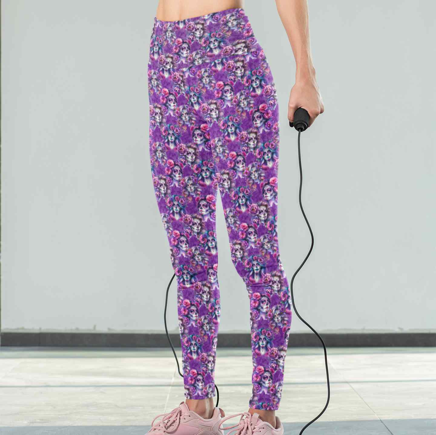 Amethyst Afterlife leggings mockup featuring La Catrina images with flowing hair with tints of pink, mauve and blue. vibrant pink and purple flowers in their hair on a rich purple background. 