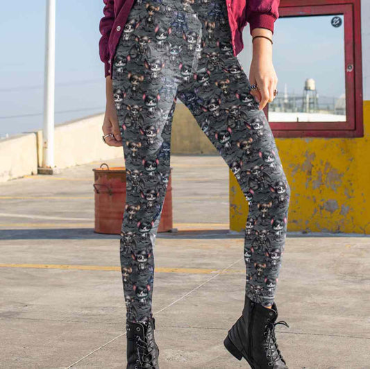 girl wearing leggings featuring a pattern with cartoon emo bats in various poses and expressions, predominantly in shades of gray, with side pockets. 