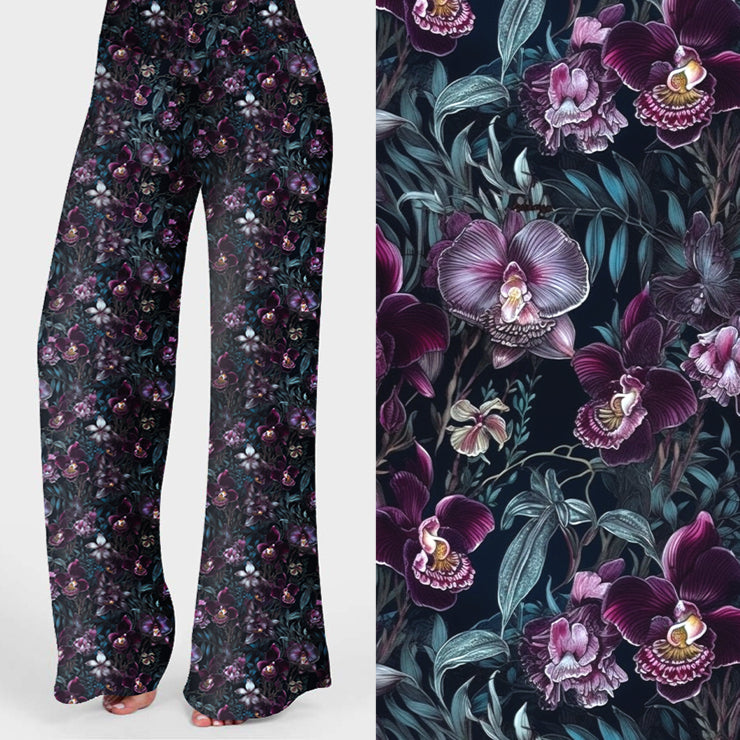 Wide leg lounge pants with dark floral print featuring purple and white orchids on a black background.