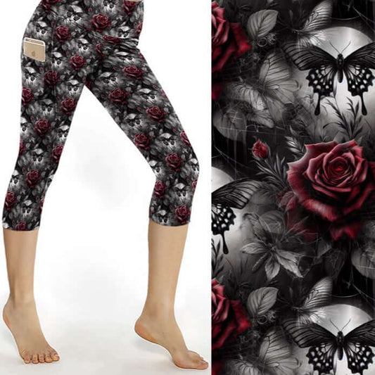 Capri leggings featuring glowing blue butterflies, skulls, and dark florals under a moody purple and black backdrop
