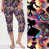 Capri jogger pants with a Wonderland theme featuring black silhouettes of Alice, the Mad Hatter, rabbits and cats. Neon rainbows, spirals, glitter, stars and candy swirls pop against a colourful cosmic background.